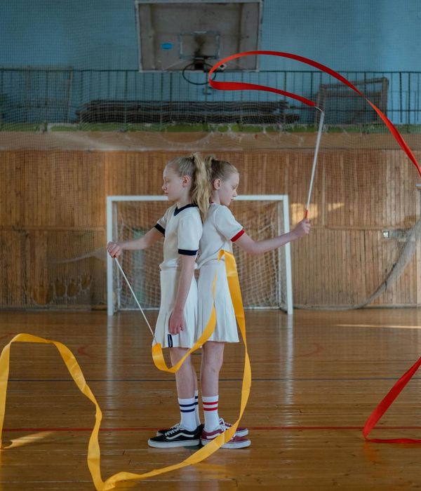 Young woman in sport wear performing rhythmic movements outdoors